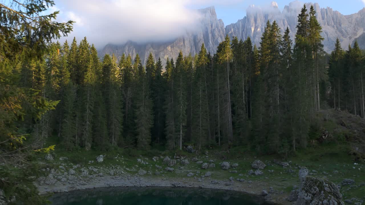 langsom dolly afslører, etablerer optagelser af charmerende teal dam med klippe bjerge i baggrunden i dolomitterne