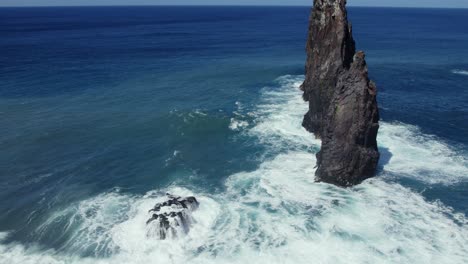 dramatic coastal waves crashing against rocky sea stacks