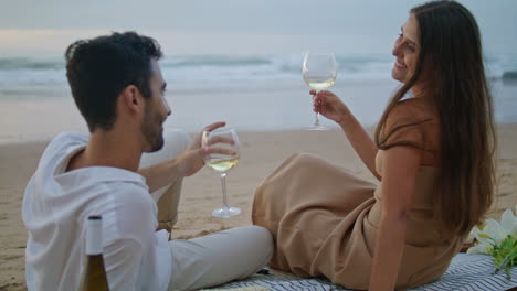 sensual couple celebrating vacation seashore. romantic family clinking glasses