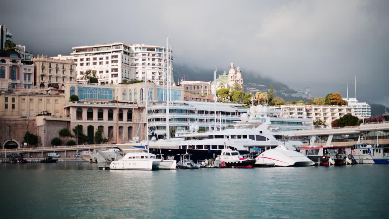 La Condamine, Monaco - October 4, 2024: View of boats docked in the Monaco Marina with the skyline of the city on the background