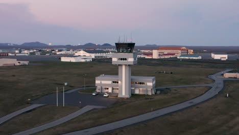 perfect cinematic aerial flying towards air traffic control tower in iceland