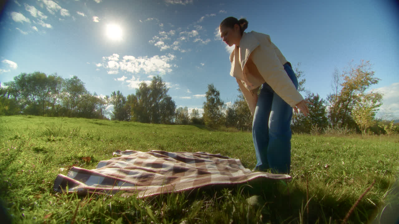 Woman preparing for a picnic in a park