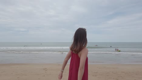 young asian woman wear red dress and walking relaxing on the beach at summer vacation holidays in slowmotion