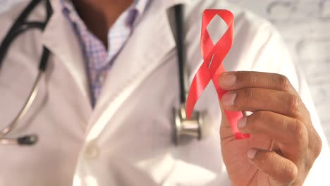 doctor holding a red ribbon: aids awareness