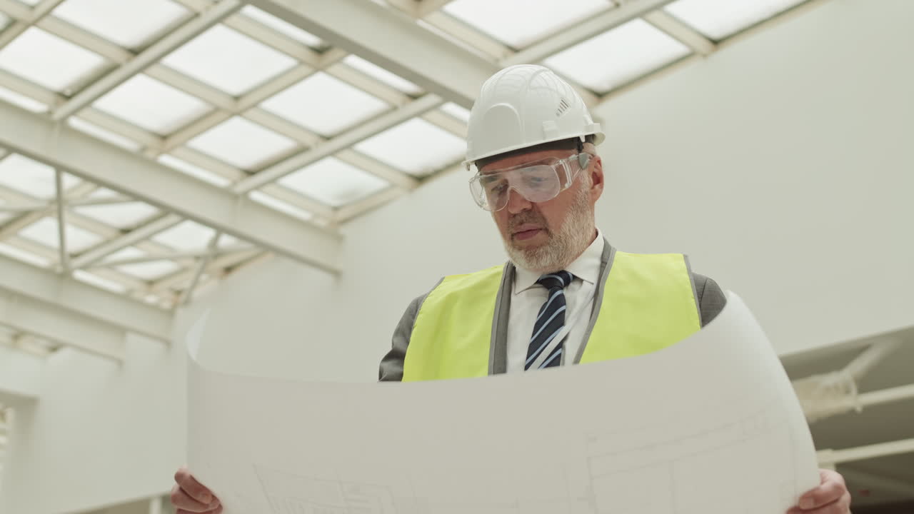 Foreman Looking Carefully at Project Paper