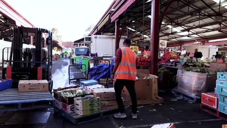 man unloading produce at queen victoria market