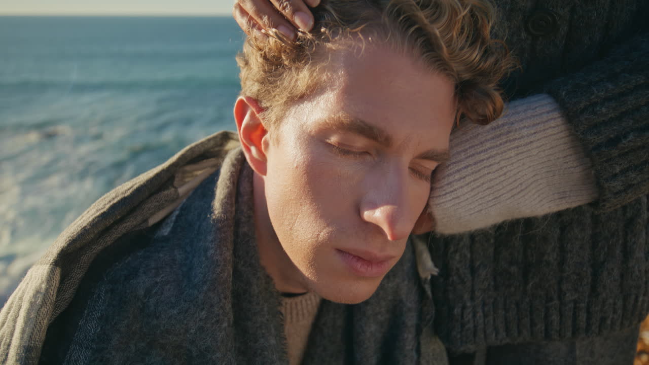 Closeup upset boyfriend leaning girlfriend body sea background. Loving couple