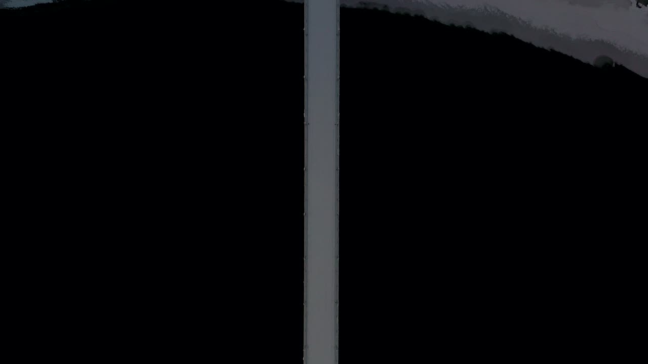 Birds eye view of suspension bridge over black dark water