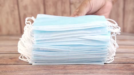 stack of face masks on wooden table