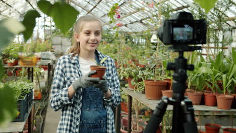 girl vlogging about plants in a greenhouse