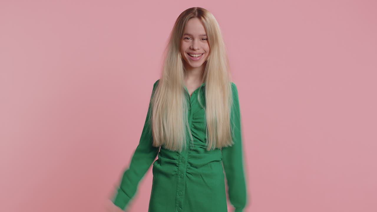 Comical funny caucasian woman making playful silly facial expressions fooling around showing tongue