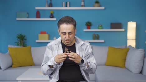 penniless man looking at his empty wallet.