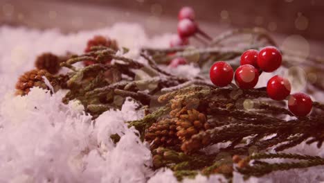 animación de nieve cayendo y manchas de luz y bayas de navidad.