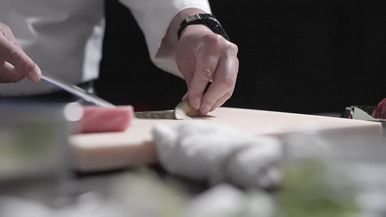 A static shot of a sushi chef slicing fresh avocado for sushi rolls, highlighting ingredient preparation. Perfect for showcasing sushi making, Japanese cuisine, and culinary techniques.