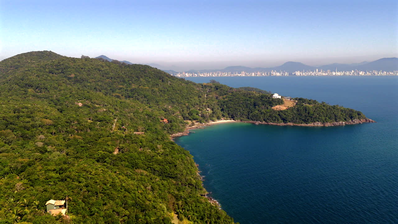 Aerial view of Porto Belo coastline with Itapema city skyline in the background, Santa Catarina, Brazil