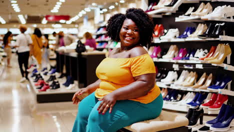 happy woman shopping for shoes in a retail store