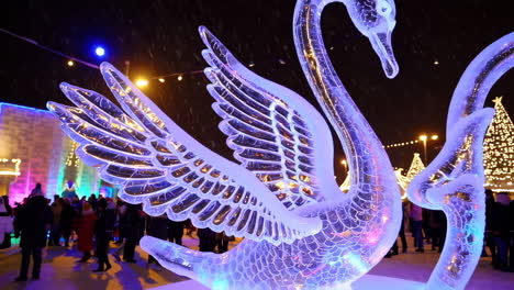 ice swan sculptures at night