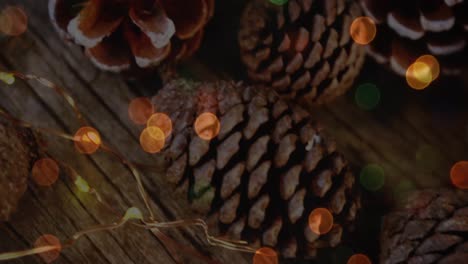 animation of christmas pine cones decorations with glowing lights