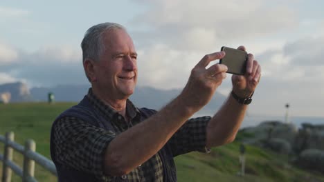 senior man taking photo on his mobile phone