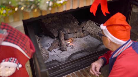 man lighting fireplace on christmas day