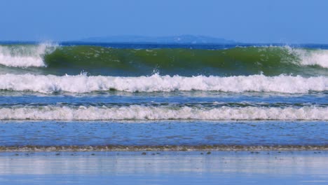 ocean waves crashing on sandy beach