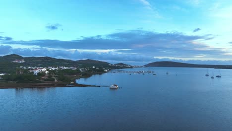 Flying-along-the-coastline-of-Spain-with-yachts-moored-near-boat-house