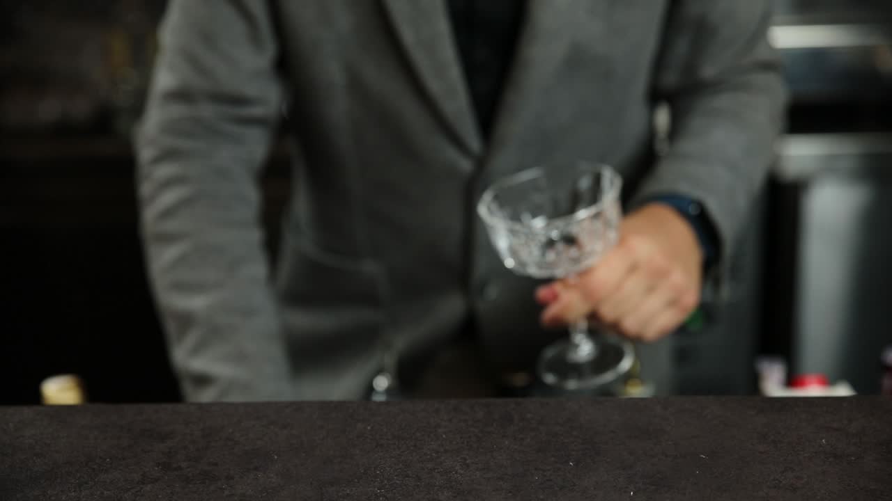 Bartender holding an empty cocktail glass