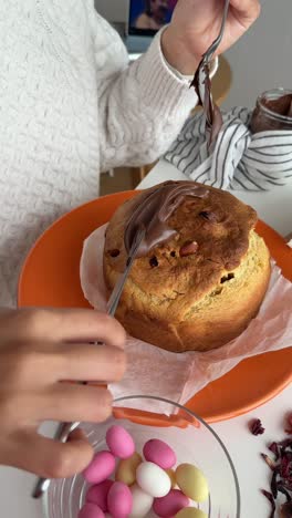 decorating a panettone with chocolate spread