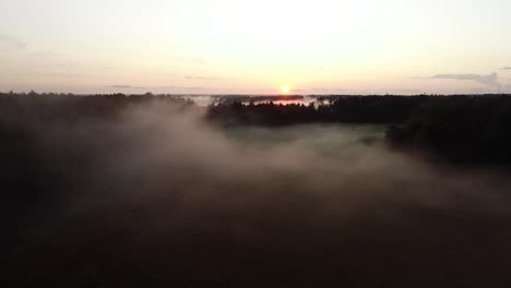 flight above sunset fog in golden hour after rain