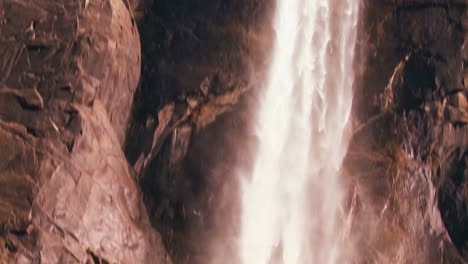 tilt down to follow water flowing from s a beautiful waterfall in yosemite national park