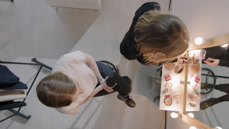 top view of mua applying make-up on woman