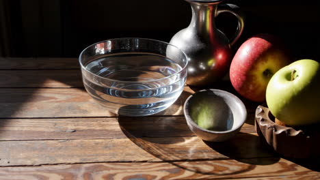 still life with apples and water bowl