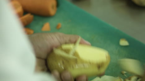 restaurant chef effortlessly peeling potatoes