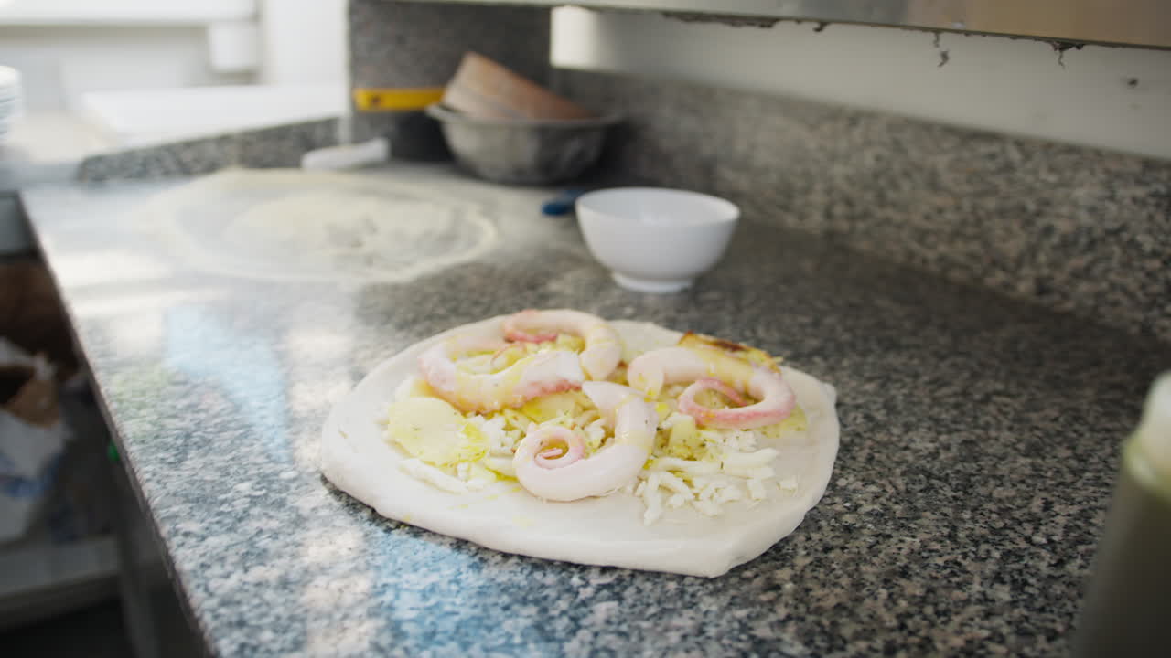 Chef Putting Some Oil During The Pizza With Octopus Preparation