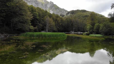 Drone-video-over-mountain-alpine-lake-Moutsalia-Gramos-summer-low-angle