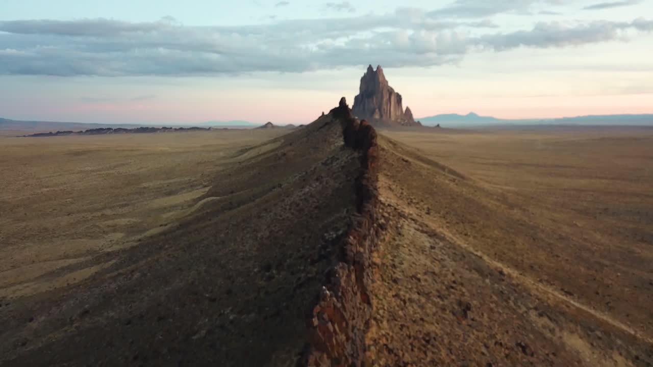 4k aerial flight above a beautiful rock formation leading to Shiprock