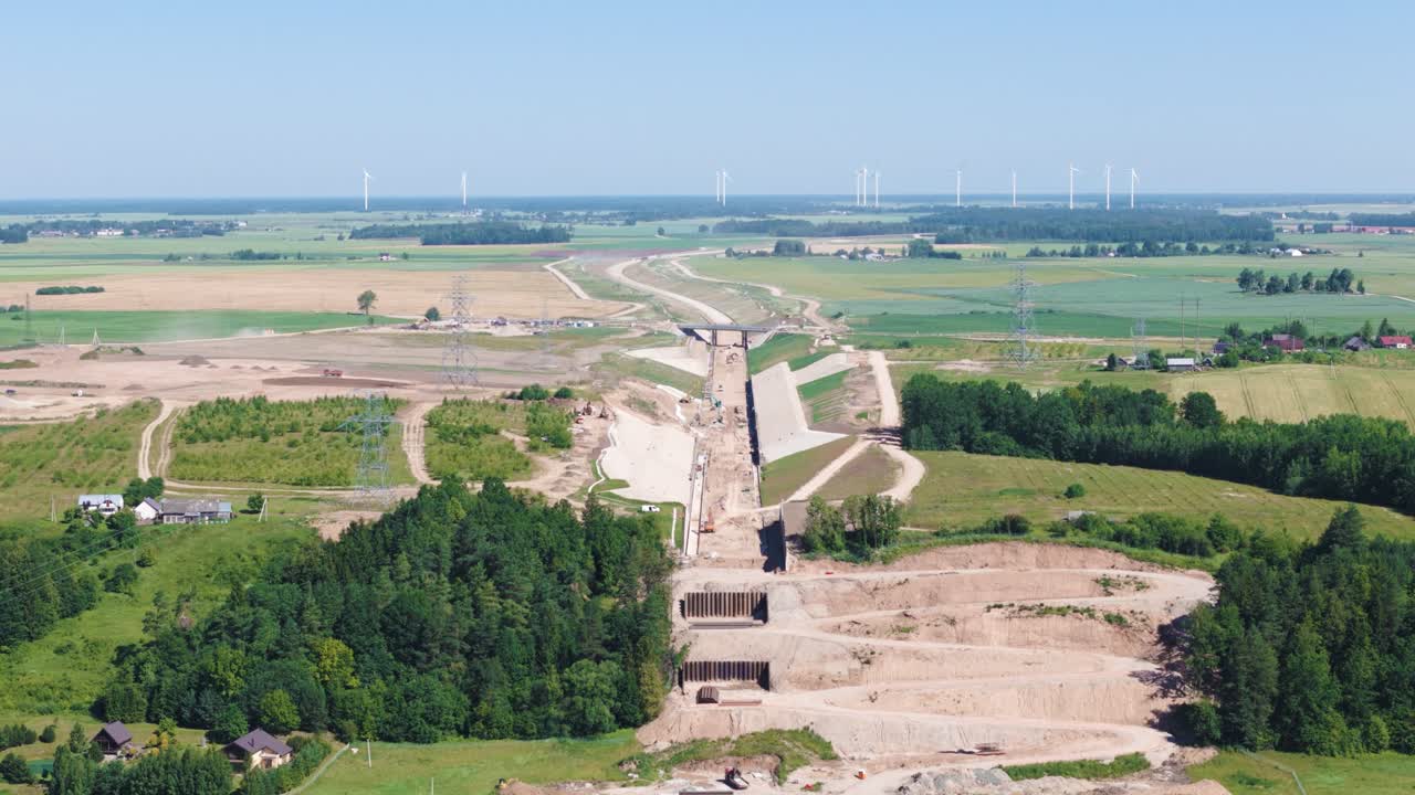 Railway construction project over farmland fields of Lithuania, aerial view