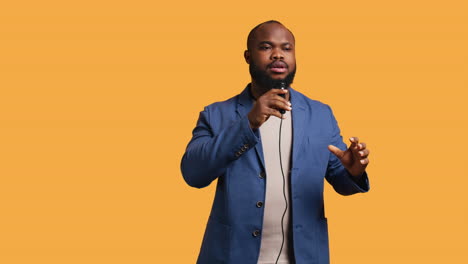 lecturer holding monologue using microphone, studio background