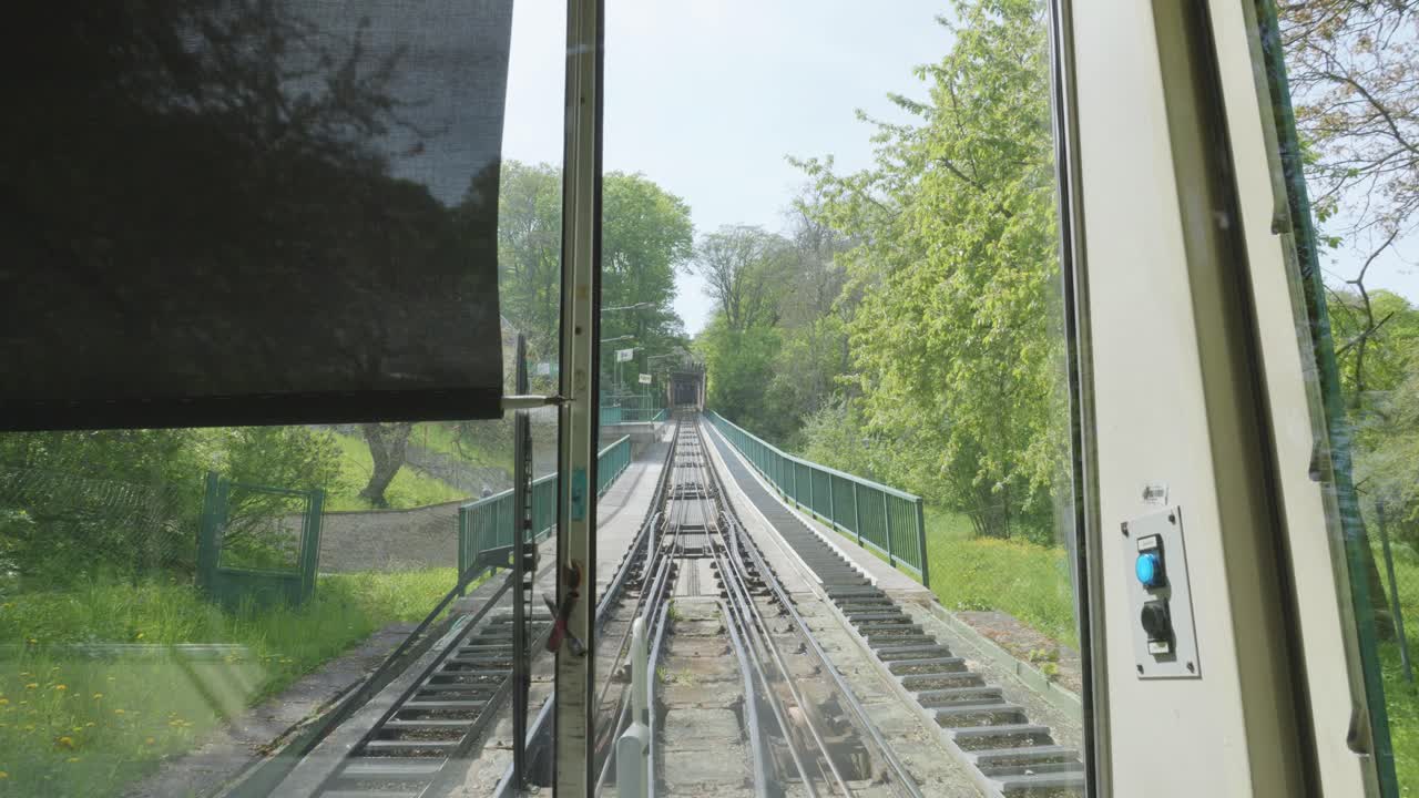 Petř&iacute;n funicular approaching the station in Petrin Hill in Prague