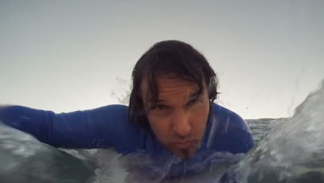 surfer swimming in sea