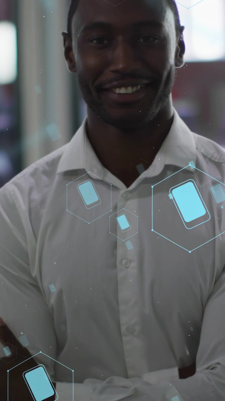 Vertical video: Man shifting hand as camera rising blue hex phone icons floating over him for tech