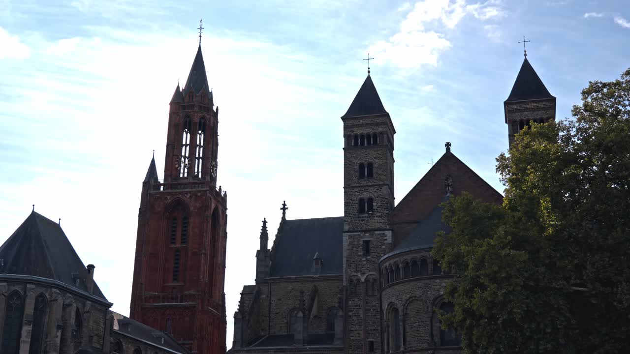 The Sint-Janskerk (St. John's Church), one of the city's most recognizable landmarks located on the famous Vrijthof square. The image highlights the lively, historic atmosphere of the Dutch city