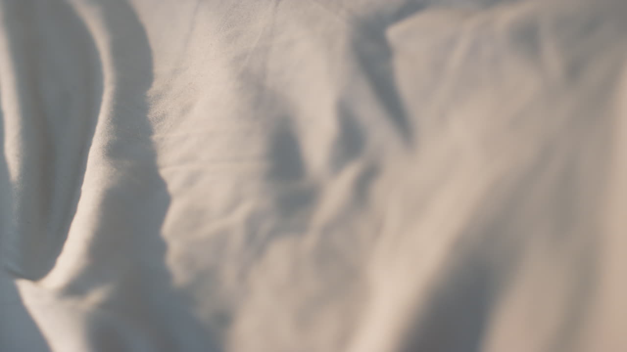 Closeup awake girl looking camera in morning sunlight. Happy woman covering face