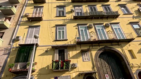 yellow building with balconies and arched doorway