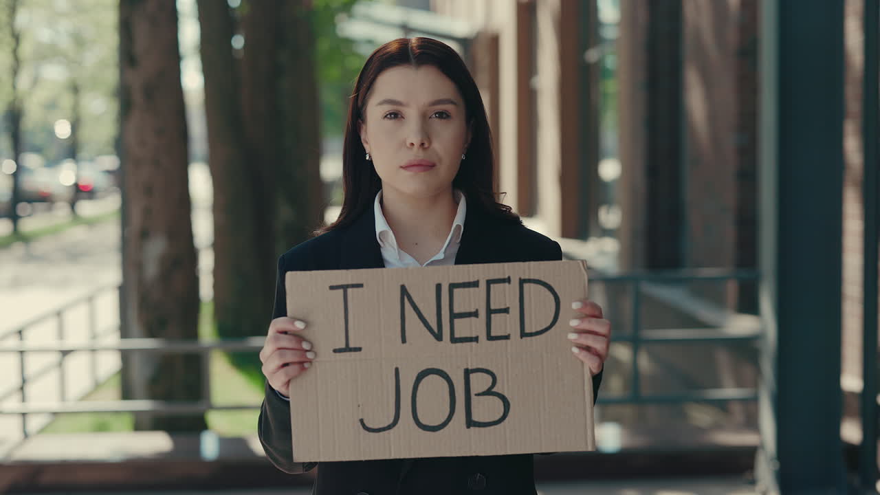 Woman Holding a Cardboard Sign Seeking Employment