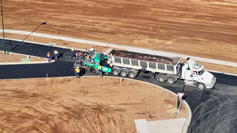 Aerial View of Road Construction: Asphalt Paving in Progress with Heavy Machinery and Workers
