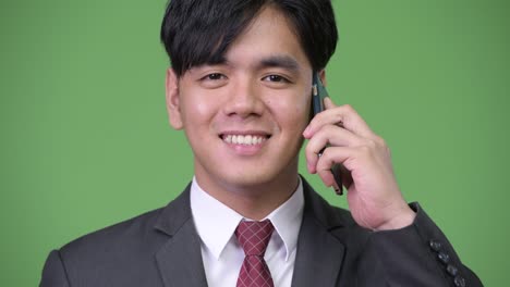 young handsome asian businessman using mobile phone