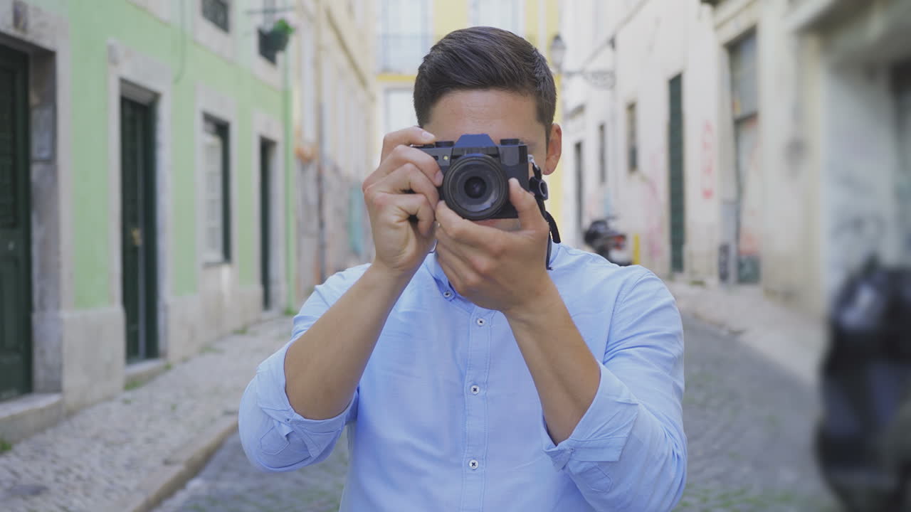 Giovane fotografo concentrato scatta foto per strada