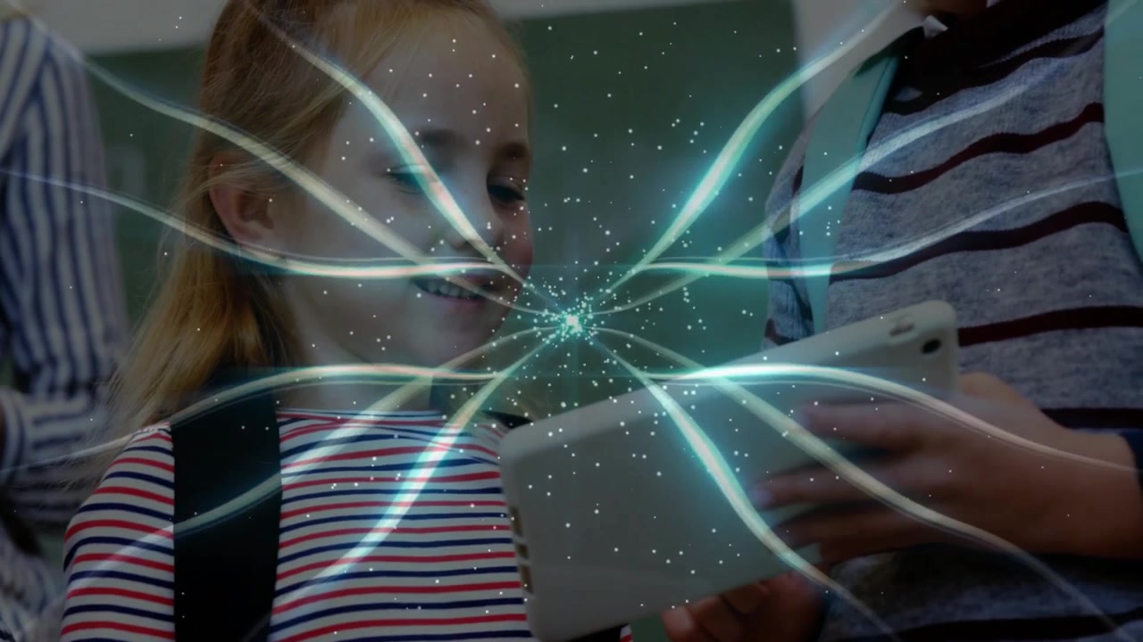 Elementary students tapping tablets and causing glowing filaments sweeping screens for learning