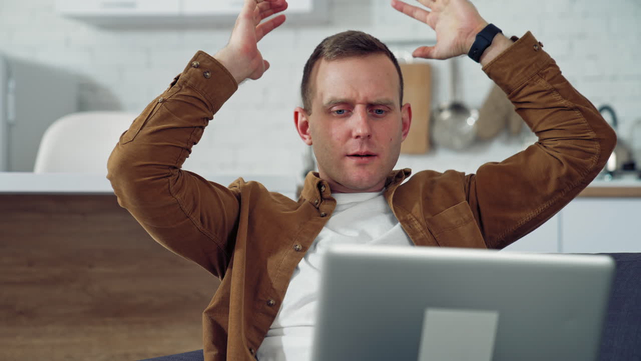 Handsome Man Using Laptop Computer. Young man with laptop computer working at home office